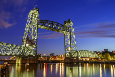 Low angle view of illuminated bridge at night