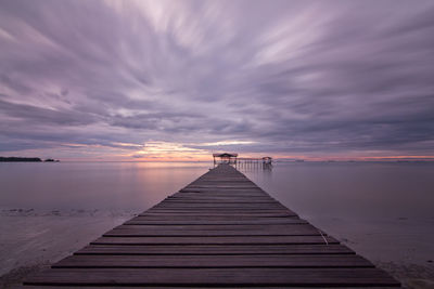 Jetty leading to calm sea