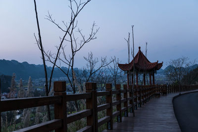 Built structure by trees against sky