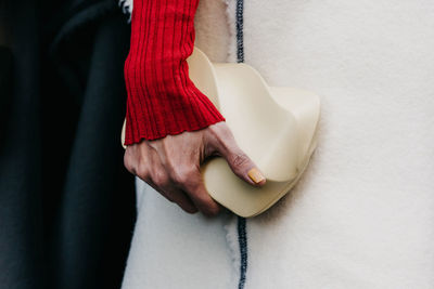 Midsection of woman holding heart shape decoration