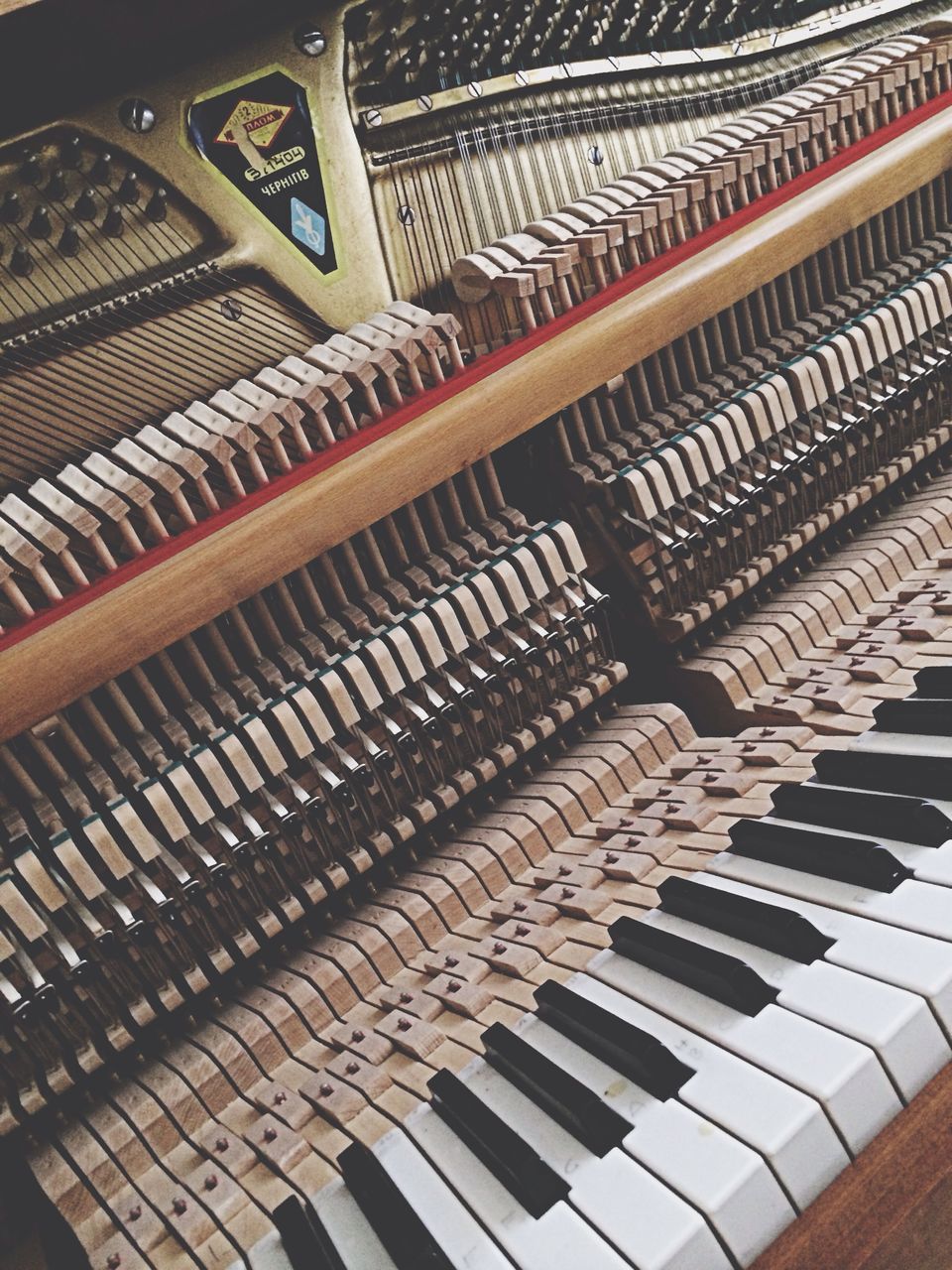 indoors, music, high angle view, arts culture and entertainment, repetition, in a row, pattern, full frame, close-up, order, backgrounds, large group of objects, no people, piano key, musical instrument, arrangement, education, piano, abundance, design