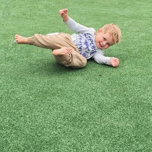 Little boy playing in grassy field