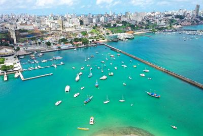 High angle view of city by sea against sky