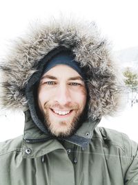 Portrait of smiling woman in snow