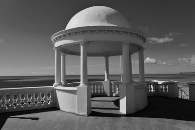 Gazebo in sea against sky