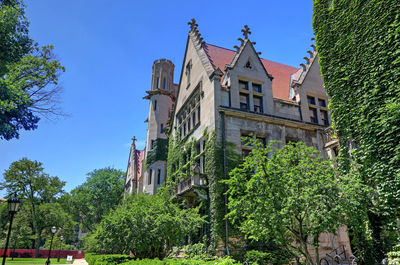 Low angle view of buildings against clear blue sky