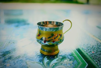 Close-up of tea cup in swimming pool