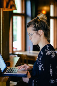 Side view of woman using mobile phone