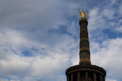 Low angle view of statue against cloudy sky