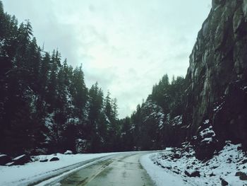 Road passing through snow covered landscape