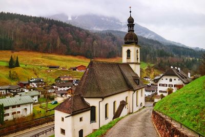 High angle view of church amidst buildings against sky