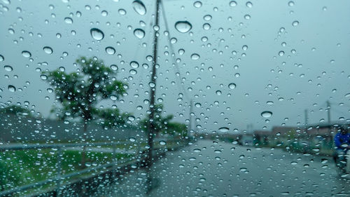 Full frame shot of wet glass window in rainy season