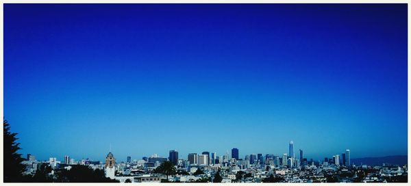 View of cityscape against blue sky