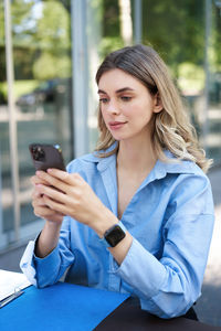 Young woman using mobile phone