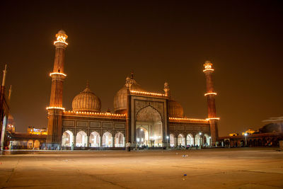 Illuminated building against sky at night