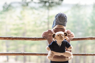 Rear view of woman with teddy bear