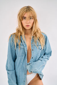 Portrait of young woman against white background