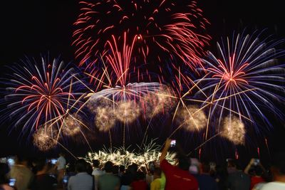 Low angle view of firework display at night