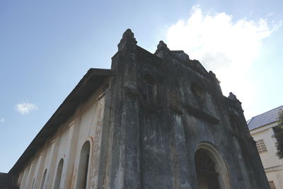 Low angle view of old building against sky