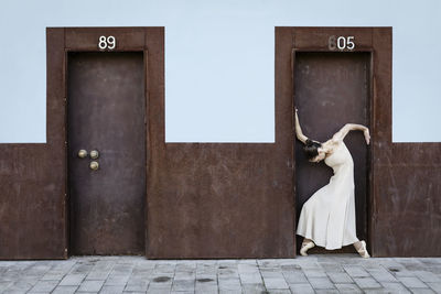 Full length of woman standing at doorway