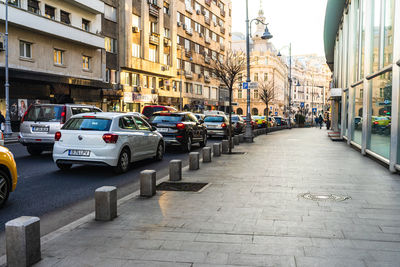 Cars on street amidst buildings in city