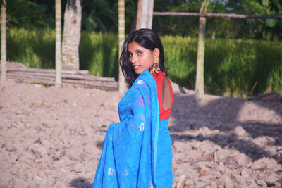 Portrait of girl standing on land