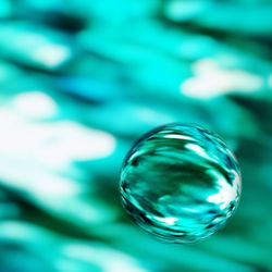 Close-up of bubbles against blue sky