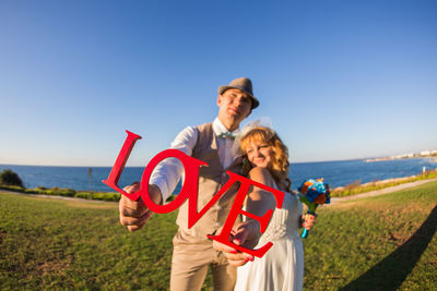 Portrait of a smiling young couple on land