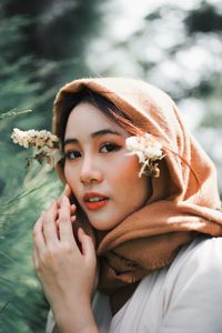 Portrait of young woman with flowers