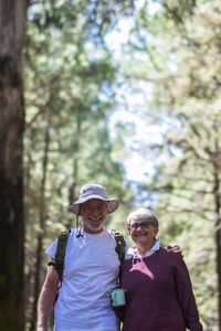 Side view of woman standing in forest