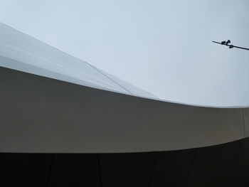 Low angle view of silhouette building against sky