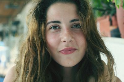 Close-up portrait of smiling young woman