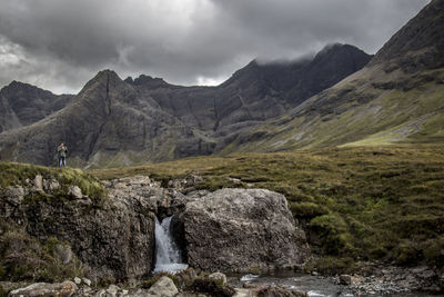 Scenic view of mountains against cloudy sky