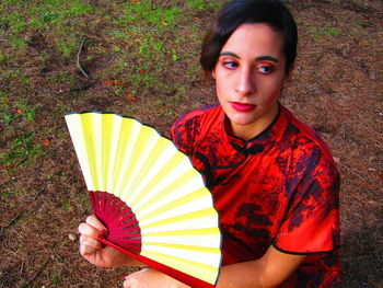 Portrait of young woman holding umbrella