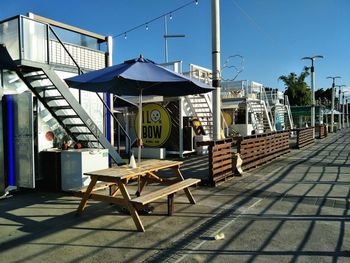 Empty chairs and tables against sky