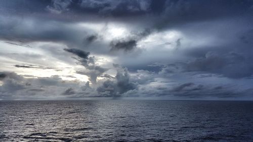 Scenic view of sea against storm clouds