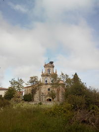 Low angle view of built structure against cloudy sky