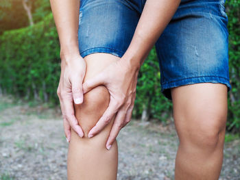 Midsection of couple holding hands