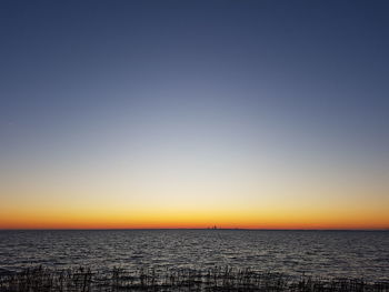 Scenic view of sea against clear sky during sunset