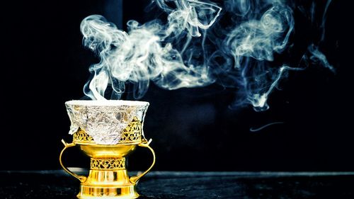 Close-up of smoke stack against black background