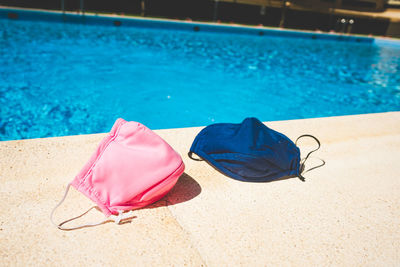 High angle view of lounge chairs by swimming pool