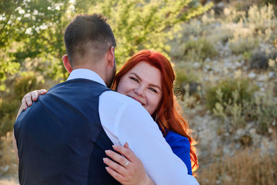 Rear view of couple standing outdoors