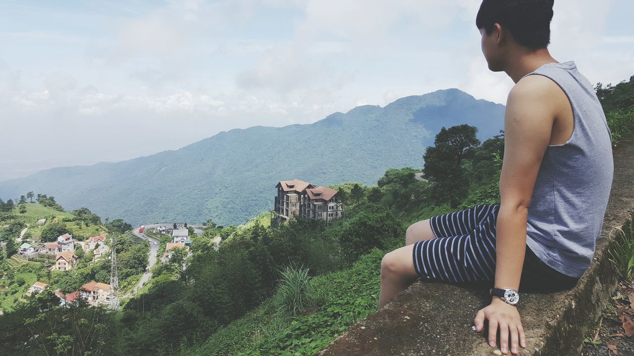 mountain, lifestyles, leisure activity, tree, sky, mountain range, casual clothing, person, standing, young adult, men, nature, full length, day, sunlight, scenics, landscape, beauty in nature