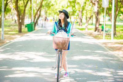 Woman riding bicycle on road