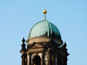 High section of building against clear blue sky