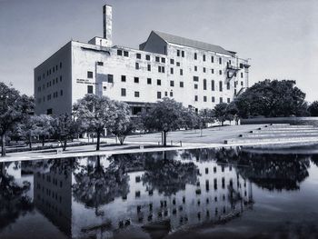 Reflection of building in lake against sky