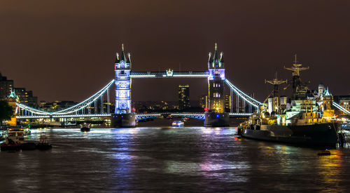 Illuminated ship in thames river against tower bridge