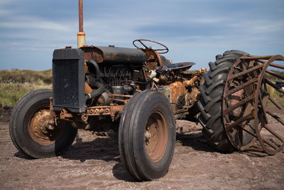 Abandoned truck on field against sky