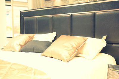 Low angle view of messy bed at home