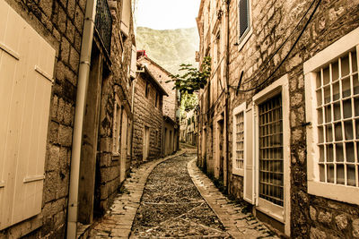 Narrow alley amidst old buildings in town